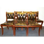 A set of six leather covered sabre legged mahogany dining chairs.