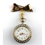 A silver and rose gilt (worn stamp) open face pocket watch set with split pearls and decorated with