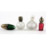 A miniature hallmarked silver and green glass egg shaped smelling salts bottle and three miniature