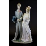 A Lladro porcelain figure of a bride and groom, H. 31cm.