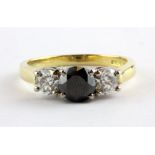 An 18ct yellow gold three diamond set ring, set with a centre black diamond, approx. 1.60ct overall,