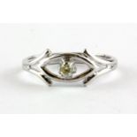 A 9ct white gold ring set with a fancy yellow diamond, (L).