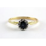 An 18ct yellow and white gold solitaire ring set with a brilliant cut sapphrie, (R).