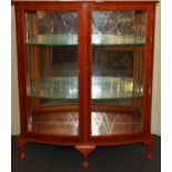 A bow front satinwood cabinet, W. 93cm H. 108cm.