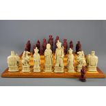 An interesting Oriental design chess set and teak board, king H. 14cm. Some pieces A/F.