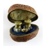 A 19th Century French walnut cased pair of perfume bottles and funnel, W. 4.5cm. A/F