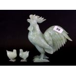 A Chinese carved jade/ hardstone figure of a cockerel, H. 20cm together with two chicks.