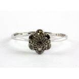 An 18ct white gold diamond set cluster ring, (T.5).