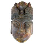 A Chinese carved wooden Guanyin mask, H. 38cm.