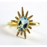 A 925 silver gilt ring set with an oval cut blue topaz and white stones, (R).