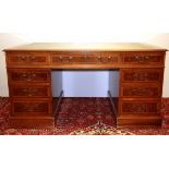 A leather topped and walnut veneered partners desk with drawers on one side and drawers and