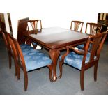 A 1920's wined-out mahogany dining table and six chairs, dining table W. 105cm and extends from