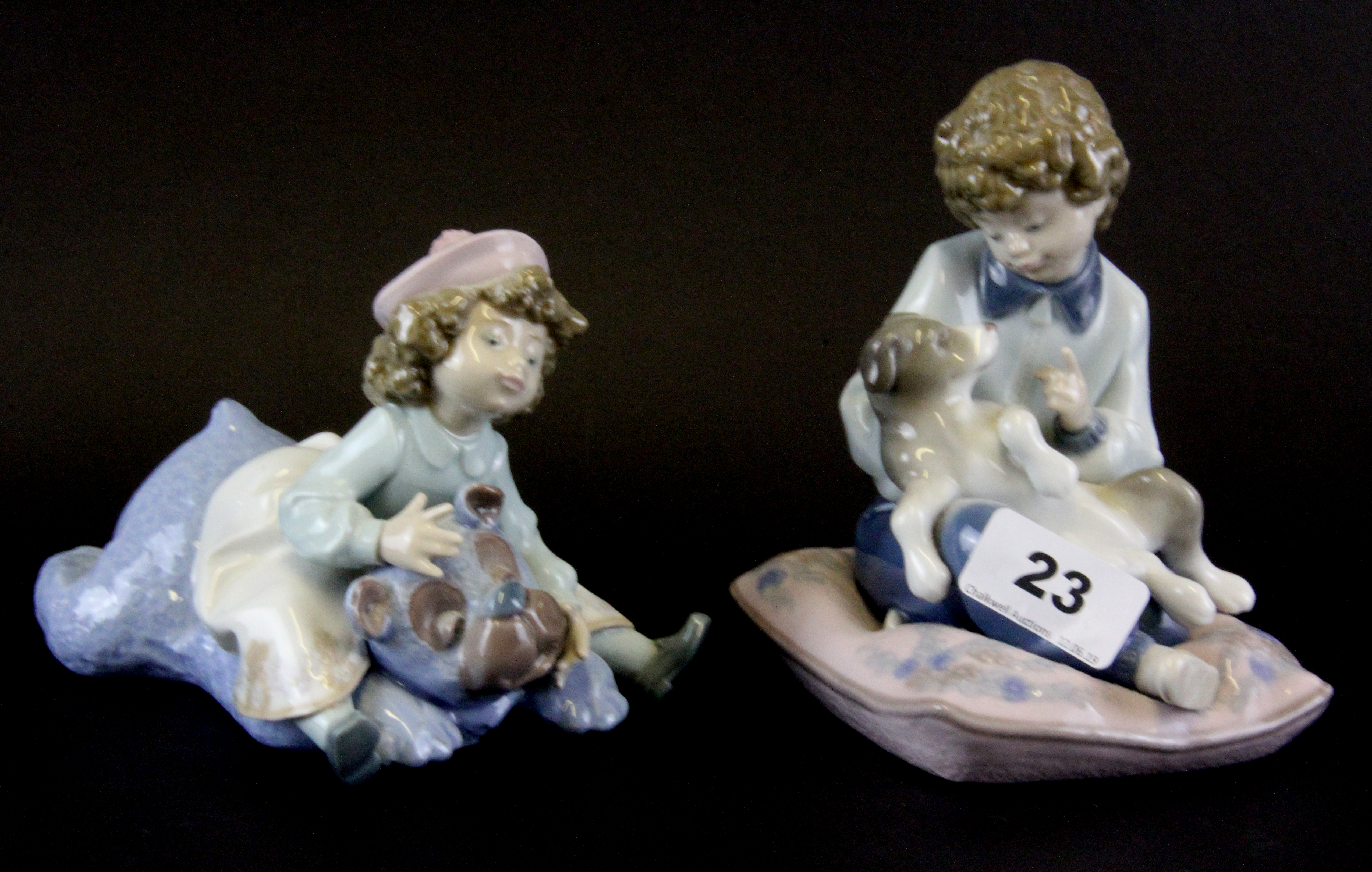 Two Lladro porcelain figures of children, tallest H. 14cm.