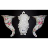A Dresden porcelain wall pocket, H. 23cm with a pair of Royal Worcester wall pockets.
