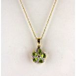 A 9ct yellow gold peridot and diamond set pendant and chain, L. 2cm.