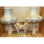 A pair of porcelain cherub table lamps and a porcelain centrepiece, lamp H. 38cm.