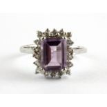 A 9ct white gold emerald cut amethyst and white stone set cluster ring, (N.5).