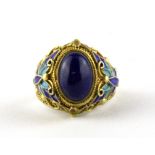 A Chinese enamelled silver gilt and blue hardstone ring (adjustable size), W. 1.8cm.