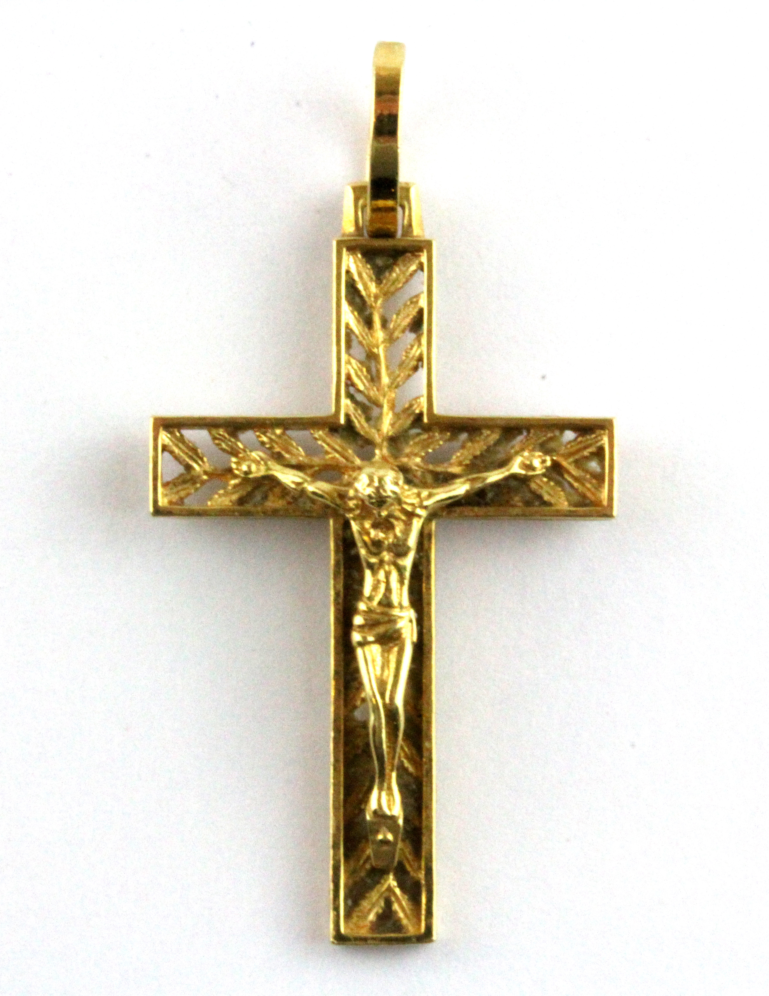An 18ct yellow gold (stamped 750) crucifix pendant, L. 4.2cm W. 3.6g.