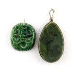 A New Zealand carved green stone Tikki, H. 3cm together with a further white metal mounted green