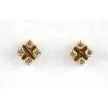 A pair of 18ct yellow gold (stamped 18ct) stud earrings set with brilliant cut diamonds.