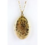 A yellow metal portrait locket pendant on a 9ct gold chain, L. 5.5cm W. 15.5g.