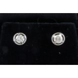 A pair of 9ct white gold (stamped 375) diamond set stud earrings, dia. 0.6cm.