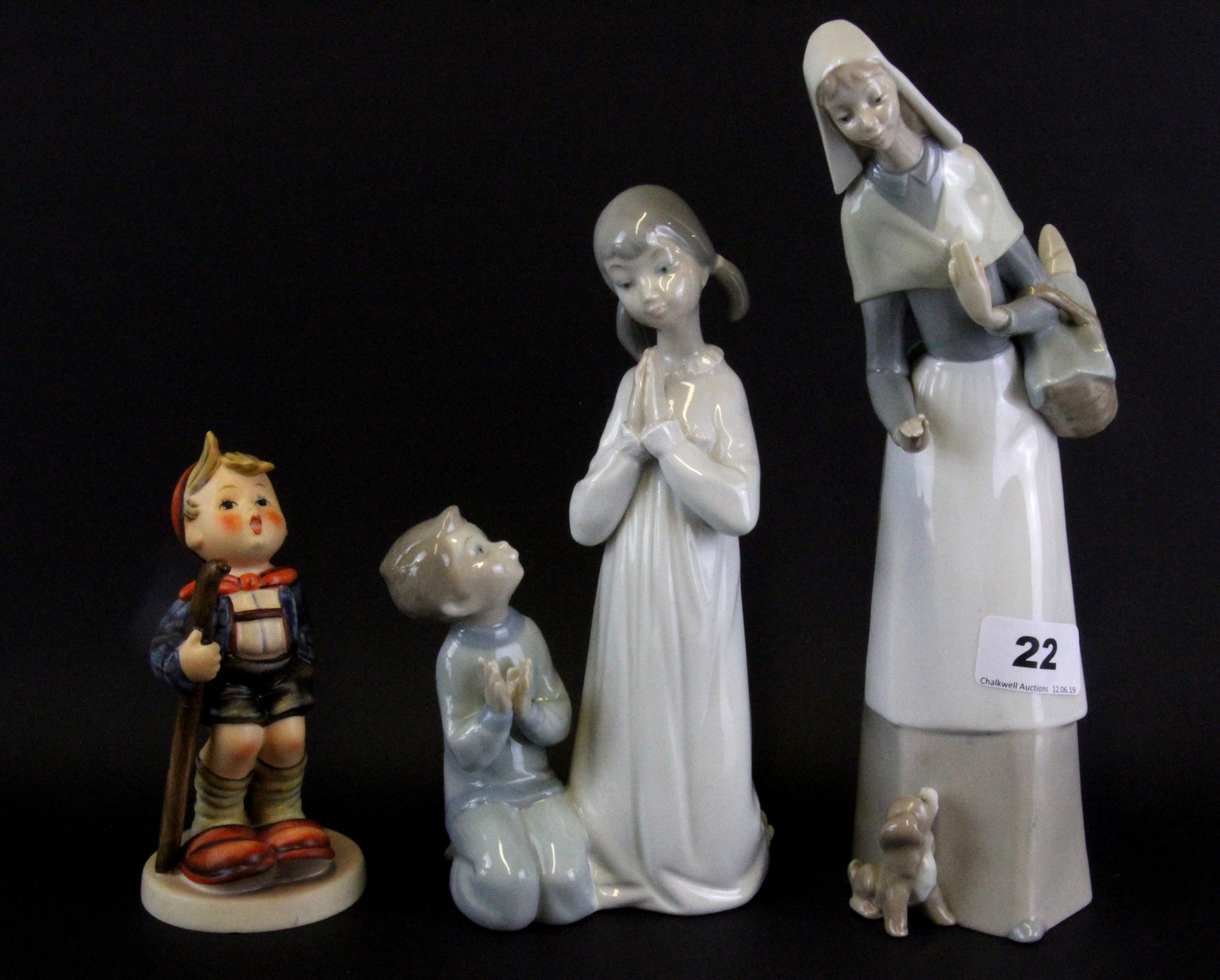 A Lladro porcelain figure of a girl with a puppy, together with a Lladro porcelain figure of a