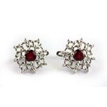 A pair of 925 silver earrings set with Swiss cut rubies, Dia. 1.5cm.