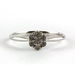 A 9ct white gold diamond set cluster ring, (L.5).