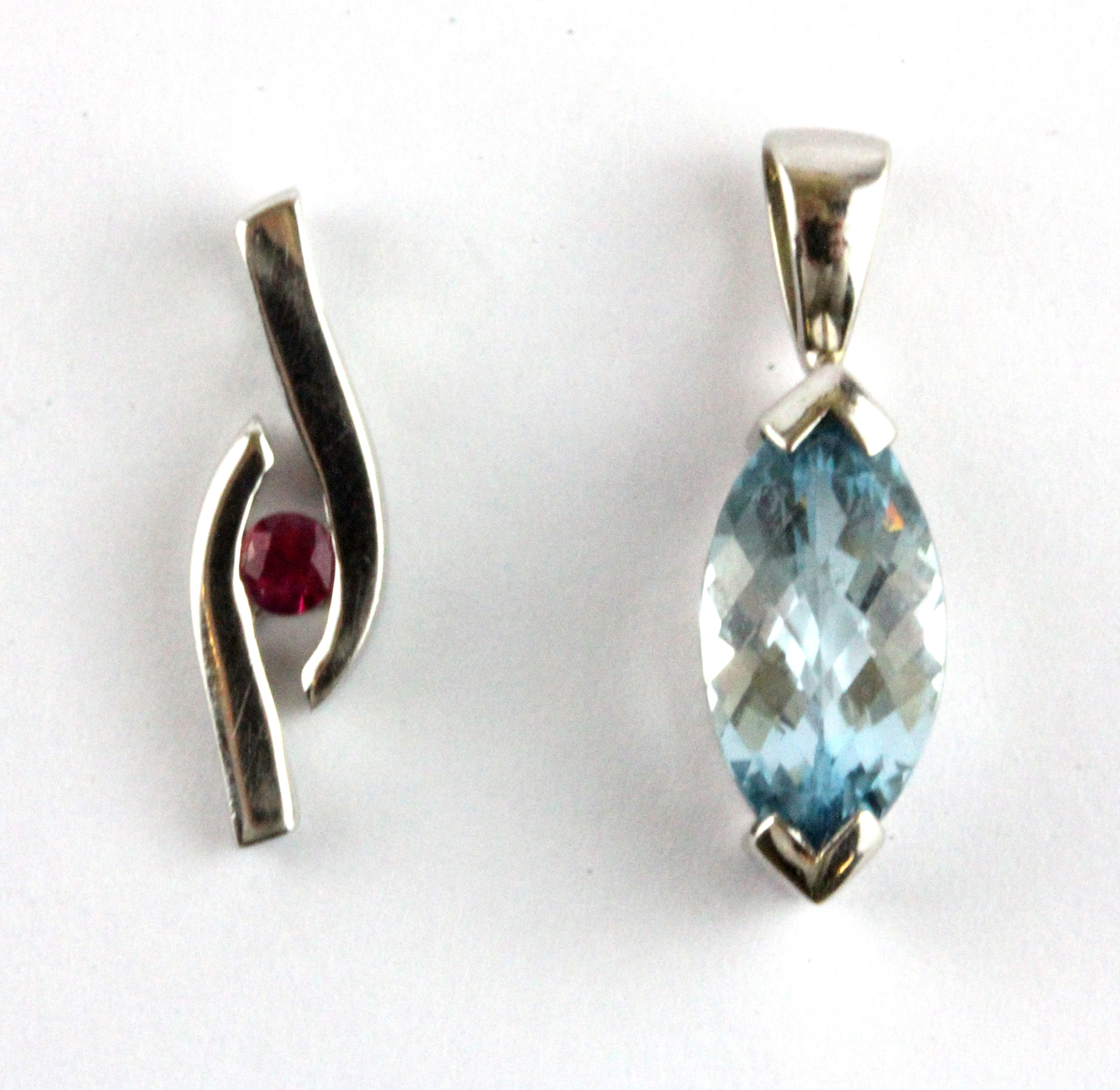 A 9ct yellow gold pendant set with a marquise shaped checker board cut Swiss blue topaz and a