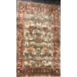 A heavy quality green ground rug, W. 197cm x ?