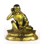 A Tibetan gilt bronze figure of the seated Buddha, H. 14cm.