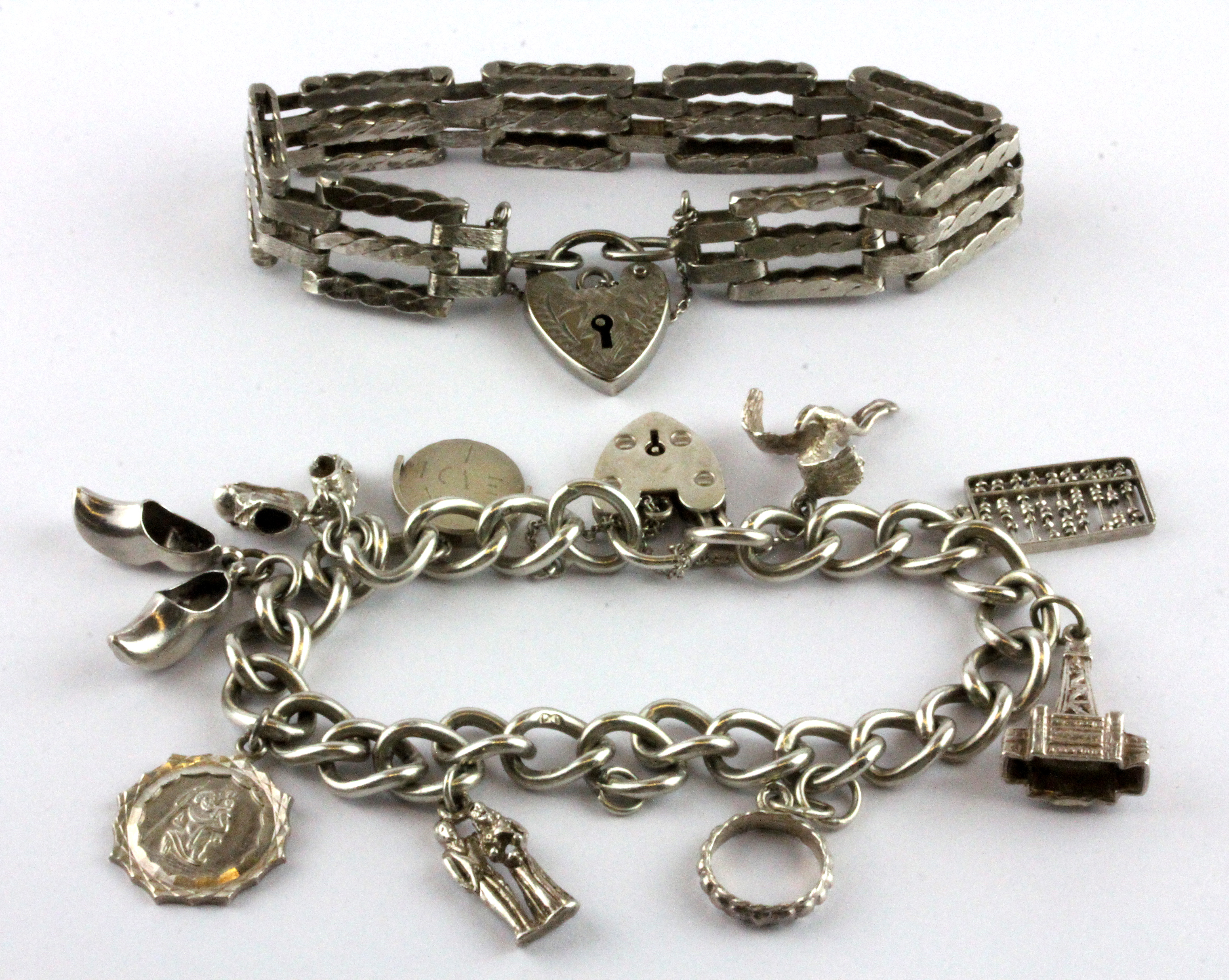 A hallmarked silver triple gate bracelet together with a hallmarked silver charm bracelet.