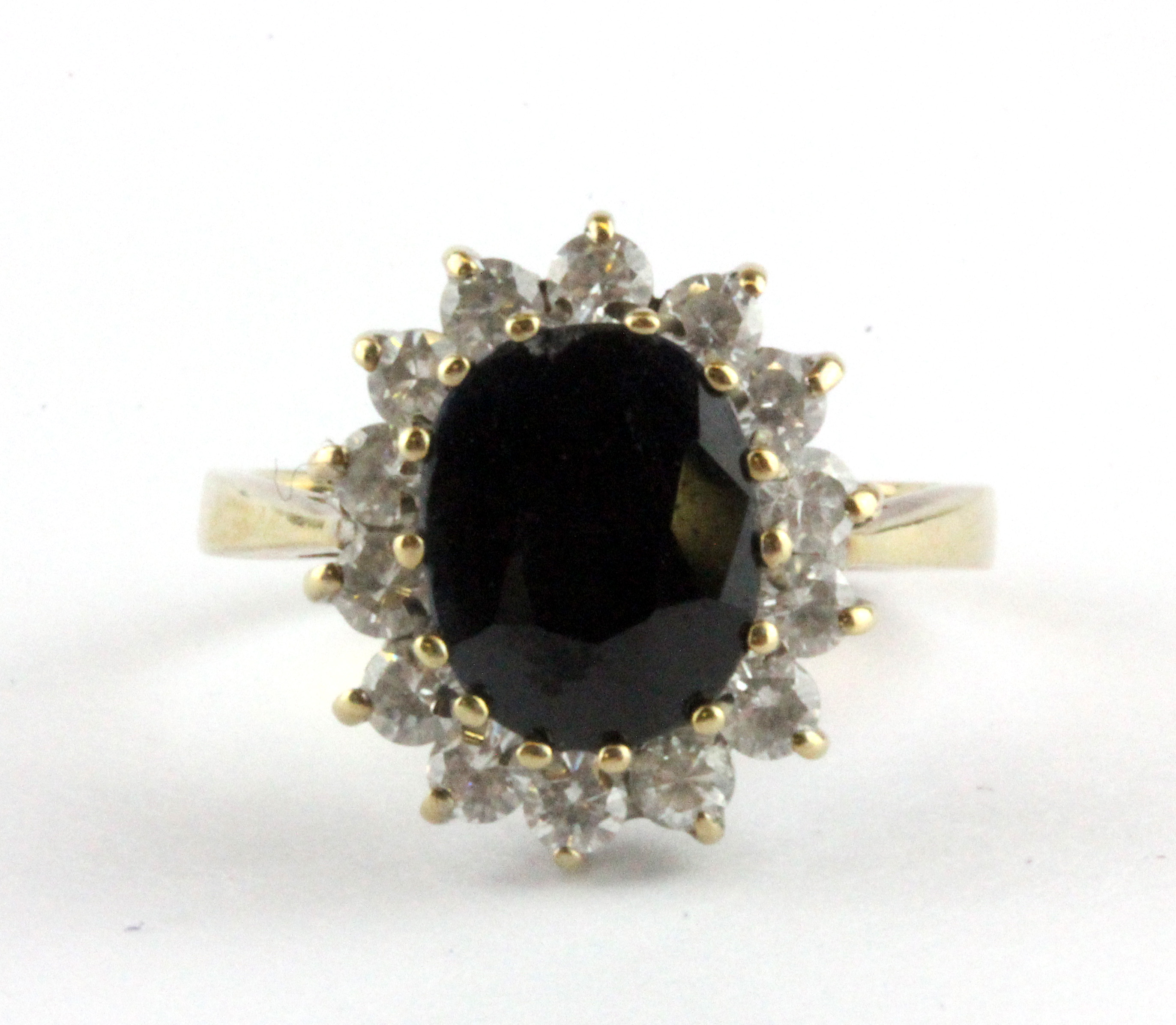 A 9ct yellow gold sapphire and white stone set cluster ring, (J).