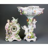 A German porcelain mantle clock with replacement movement together with a porcelain centrepiece A/F,