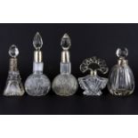 Five hallmarked silver mounted glass perfume bottles.