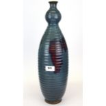 An interesting Chinese Zhun glazed ribbed terracotta vase, H. 46cm.