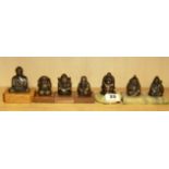 A group of seven bronzed figure paper weights, H. 8cm.