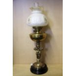 An oil lamp style electric table lamp, H. 73cm.