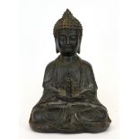 A Chinese cast iron figure of the seated Buddha holding a pagoda, H. 20cm.