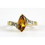 A 9ct yellow gold ring set with a marquise cut citrine and diamond set shoulders, (L.5).