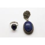 A 925 silver lapis lazuli set ring and a 925 silver lapis lazuli set pendant on a white metal