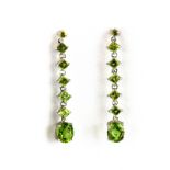 A pair of 925 silver drop earrings set with oval and step cut peridots, L. 5cm.