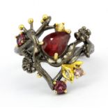 A 925 silver gilt ring snail shaped ring set with a pear cut ruby, tourmalines and other semi-