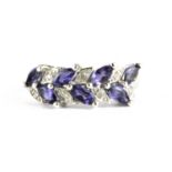 A 9ct white gold ring set with marquise cut tanzanites and diamonds, (P.5).