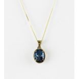 A 9ct white gold blue topaz set pendant and chain, L. 1.6cm.