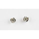 A pair of 9ct white gold (stamped 375) diamond set stud earrings.