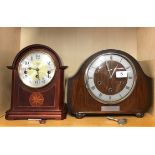 An inlaid Hermle mahogany mantle clock and a further mantle clock.