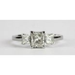 An 18ct white gold (stamped 18k) ring set with three princess cut diamonds, centre approx. 1ct,